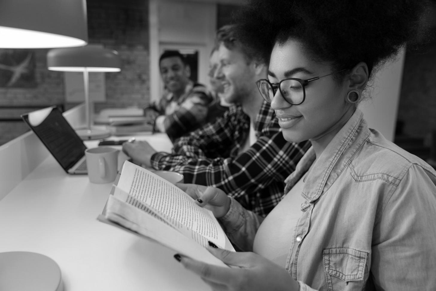 Investment research materials and financial analysis tools spread across a modern workspace